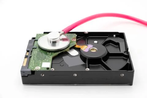 Old HDD or hard disk drive antique storage with pink stethoscope Stock Photos