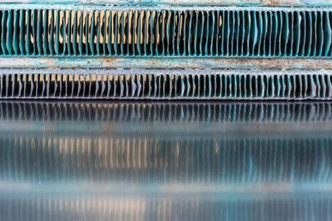 Old heating exchanger with reflection on metallic table Stock Photos