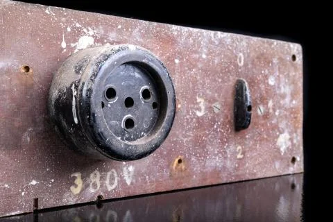 Old high voltage electric socket. Electric board with a controller. Stock Photos