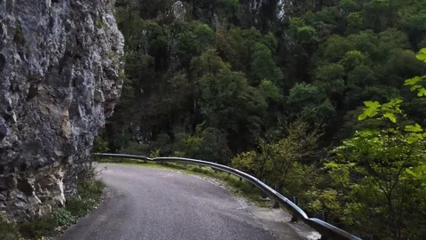 An old highway in the mountains and a mountain river. The view from the drone. Stock Footage 220573149