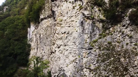 An old highway in the mountains and a mountain river. The view from the drone. Stock Footage 220573870