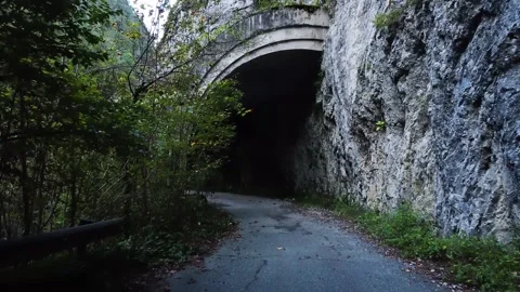 An old highway in the mountains and a mountain river. The view from the drone. Stock Footage 220574541
