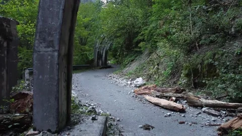 An old highway in the mountains and a mountain river. The view from the drone. Stock Footage 220574673