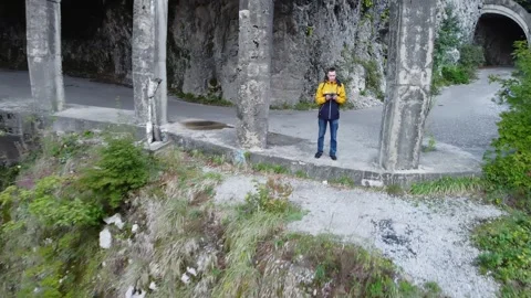 An old highway in the mountains, a mountain river in a gorge. Aerial view drone. Stock Footage 220574705