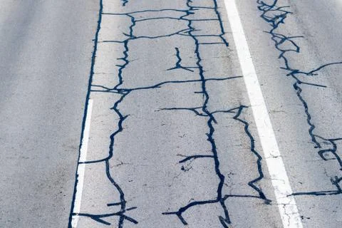 Old highway repaired with patches. Stock Photos
