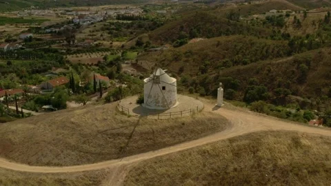 Old historical deserted windmill in Silves, Algarve, Portugal, aerial photo of t Stock Footage 164782391