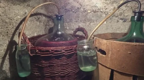 Old homemade process must fermentation process in wine carboys Stock Footage 55639619