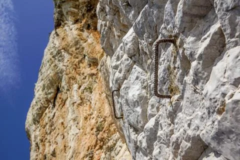 Old hook and surface of natural grungy marble abstract on rocky wall Stock Photos