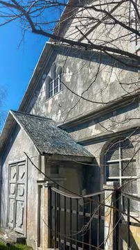 Old house with broken windows and overgrown plants outdoors Stock Photos