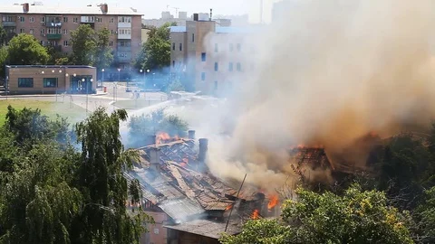 The old house caught fire, the view from the hill Stock Footage 79497265