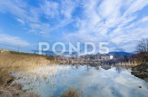 Old house on the clear cloudy blue sky Stock Photos