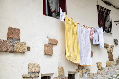 Old house with clothesline between window and window Stock Photos