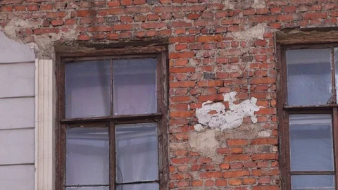 Old house facade with brick wall and couple of windows in daylight. Stock Footage 107111226