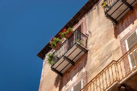 Old house with flowers on a balcony Stock Photos