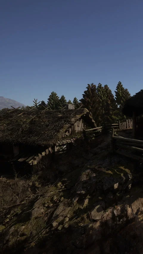 Old house in a rural area surrounded by trees and mountains at daytime Stock Footage 339037125
