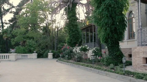 Old house with square in front of it in summer sunset lights. Video stock 76588864