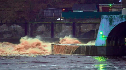 Old hydro station with spray waves in the river Stock Footage 168884399