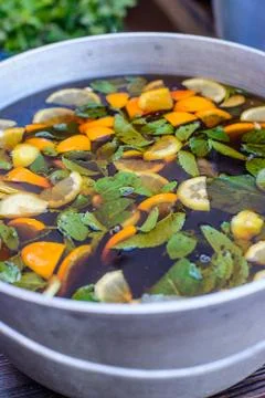 ?old ice tea from an orange in a large casserole Stock Photos