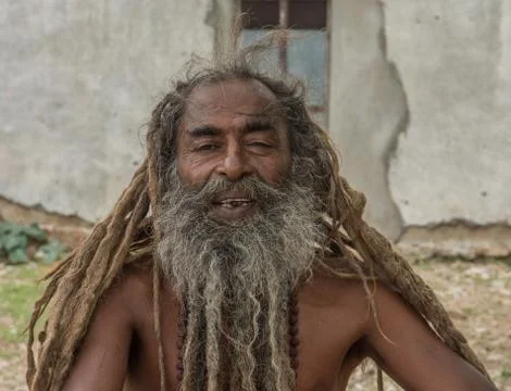Old indian baba man with threadlike hair Stock Photos