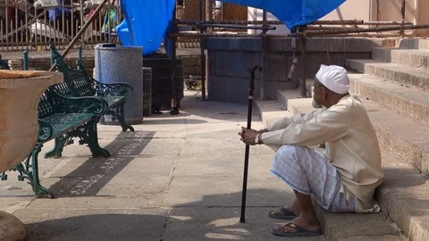 An old indian man with a cane wearing a nehru cap Stock Footage 83655370
