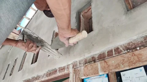 An old Indonesian builder is building a wall ventilator using traditional tools Stock Footage 198250279