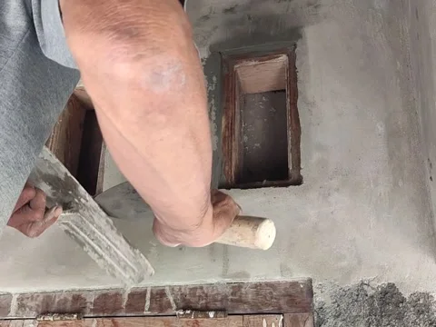 An Old Indonesian House Builder is plastering Stock Footage 197532201