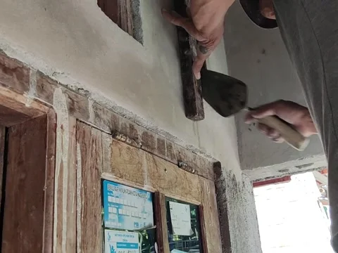 An Old Indonesian House Builder is plastering Stock Footage 197532206