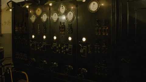 An old, industrial control panel with a variety of gauges, switches, and dials Stock Footage 301034532