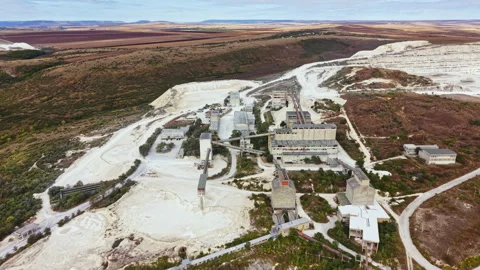 Old industrial site in remote location with abandoned buildings under a clear Stock Footage 345455659