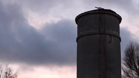 Old industrial tower with dramatic sunset and moving clouds Stock Footage 170389402