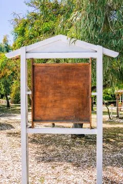 Old  information stand with empty scratched brown wooden board Stock Photos