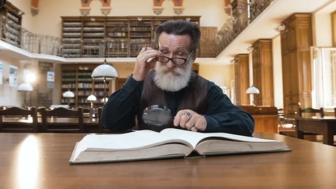 Old intelligent bearded man taking off his glasses and rubbing eyes during his Stock Footage 119310865