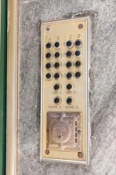 Old intercom on an old wall. Vintage background. Stock Photos