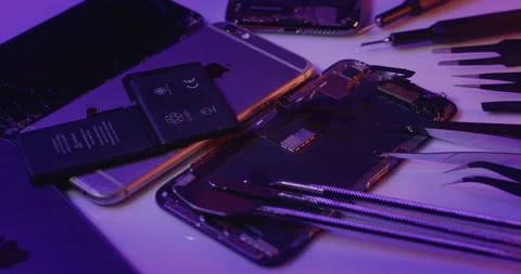 Old iPhone on top of broken Smartphone. Repairing old Smartphone. Stock Footage 237400501