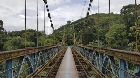 Old iron bridge over the river in the countryside of Lombok. Stock Photos