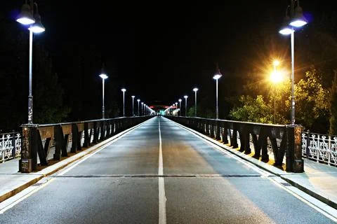 Old Iron bridge with riveted joints over the Ebro River at night in the city Stock Photos