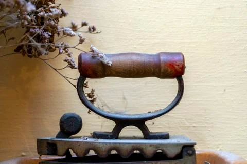 Old iron in front of a beige wall Stock Photos