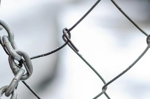 The old iron gate is locked with a chain. Breaking and entering private prope Stock Photos