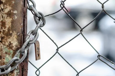 The old iron gate is locked with a chain. Breaking and entering private prope Stock Photos