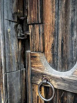 An old iron handle in the form of a ring on the wooden door Photos
