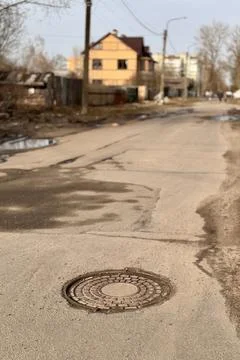 A old iron hatch with a pattern above an observation well is located on auto Stock Photos