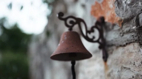 Old iron rusty bell on a stone wall Stock Footage 166121986