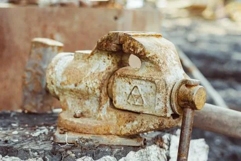 Old iron vise on the table Stock Photos