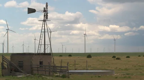 Old irrigation windmill and wind turbines share the sky and prairie of Colorado. Stock Footage 40265905