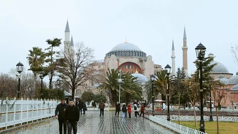 Old Islamic mosque made of red brick. Alley in front of the mosque with tourists Video stock 105273468