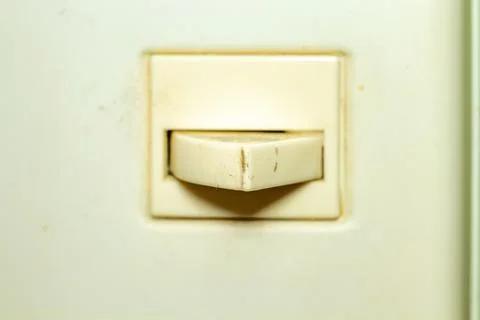 Old ivory light switch on the wall interior detail vintage style Фото
