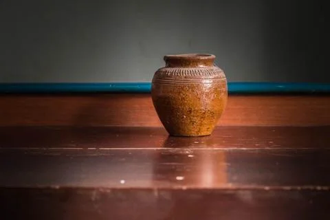 Old jar in the darkness. Stock Photos