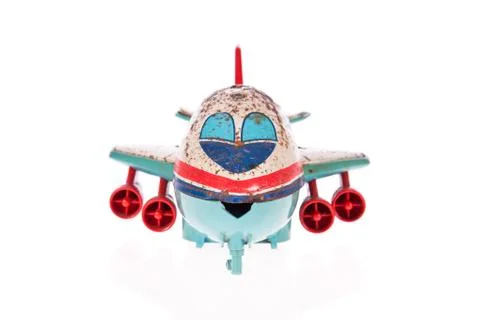 Old jet plane rusty tin toy isolated on white Stock Photos