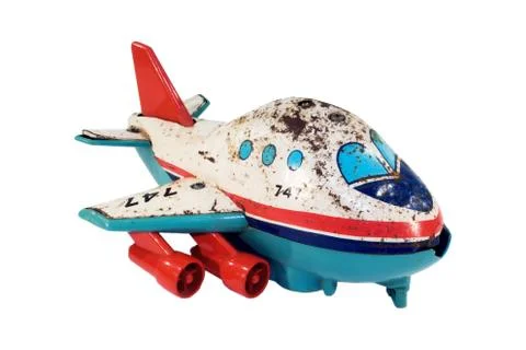 Old jet plane rusty tin toy isolated on white Stock Photos