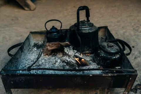 Old kettle on a fireplace Stock Photos